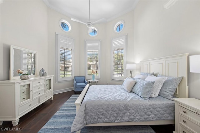 bedroom with ornamental molding, multiple windows, and dark wood finished floors