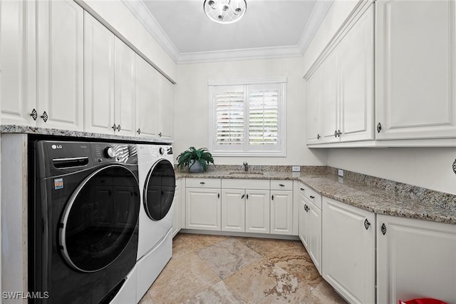 laundry room featuring cabinet space, crown molding, a sink, and separate washer and dryer