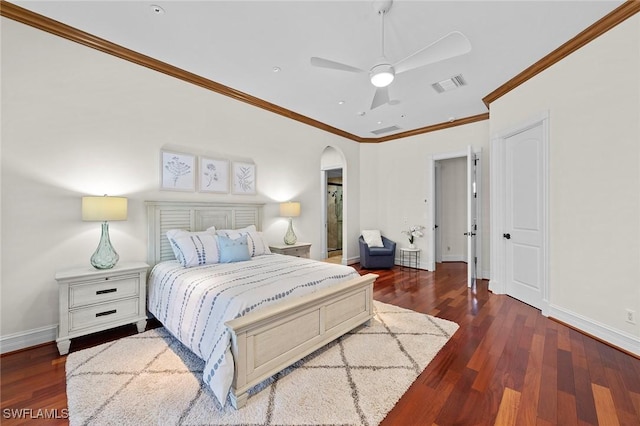 bedroom featuring arched walkways, crown molding, visible vents, wood finished floors, and baseboards