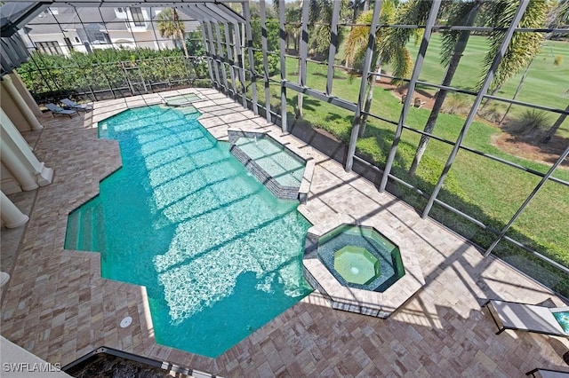 view of swimming pool with a yard, a pool with connected hot tub, a lanai, and a patio