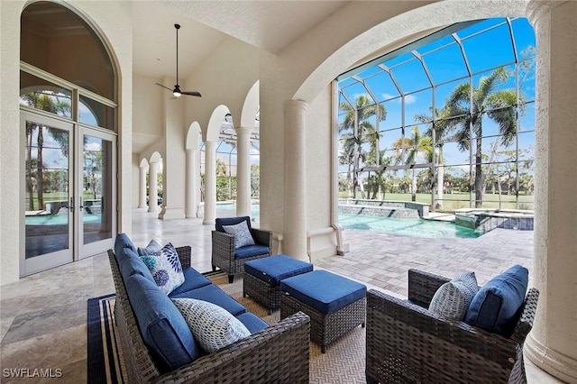 view of patio / terrace featuring french doors, a pool with connected hot tub, glass enclosure, ceiling fan, and an outdoor living space