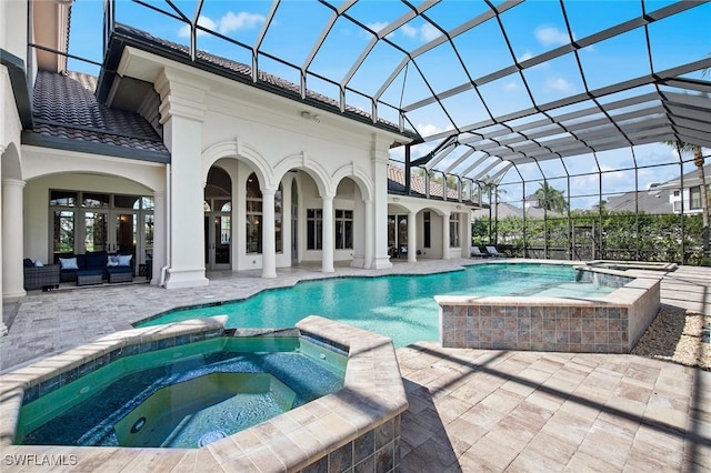 view of pool with glass enclosure, a pool with connected hot tub, a patio area, and outdoor lounge area