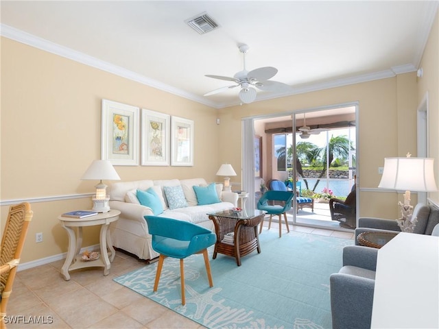 tiled living room featuring ceiling fan and ornamental molding