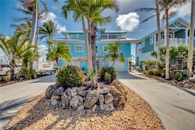 beach home featuring a garage and a balcony