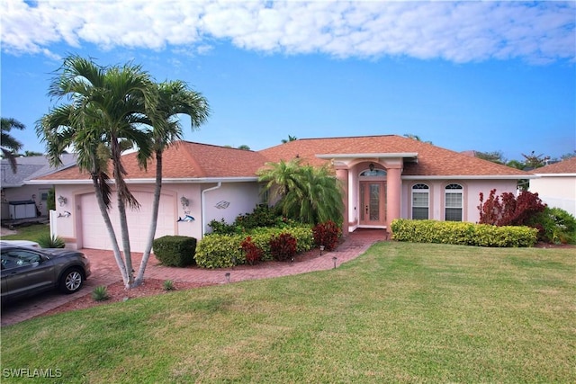 view of front of property featuring a garage and a front yard