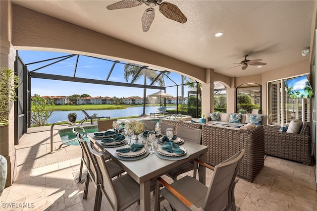 view of patio / terrace with an outdoor hangout area, ceiling fan, and glass enclosure