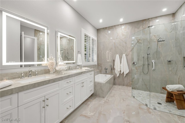 bathroom with vanity and independent shower and bath