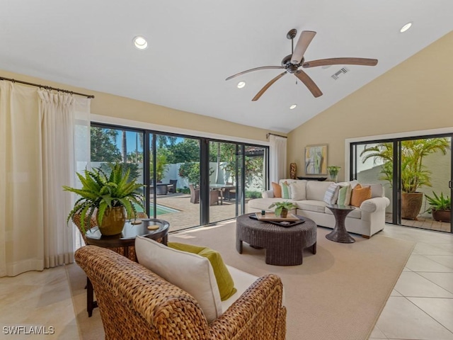 tiled living room with ceiling fan and high vaulted ceiling