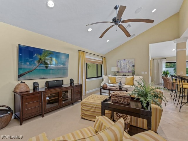 living room with high vaulted ceiling, decorative columns, ceiling fan, and light tile patterned flooring