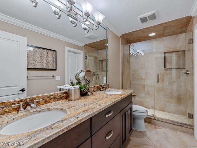 bathroom featuring vanity, a shower with door, ornamental molding, and toilet