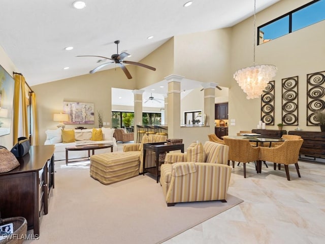 living area with high vaulted ceiling, recessed lighting, ornate columns, and ceiling fan with notable chandelier