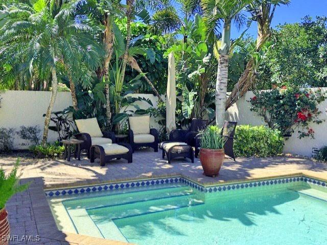 pool featuring outdoor lounge area, fence, and a patio