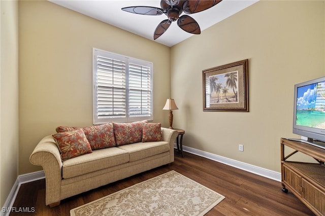 living room featuring dark hardwood / wood-style flooring and ceiling fan