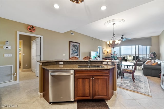 kitchen featuring decorative light fixtures, sink, a chandelier, dark stone counters, and stainless steel dishwasher