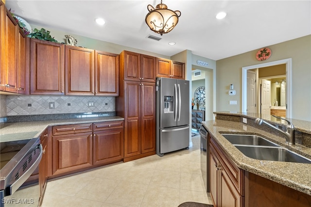 kitchen featuring sink, light tile patterned floors, appliances with stainless steel finishes, light stone countertops, and backsplash