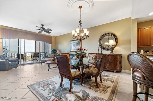 tiled dining space featuring ceiling fan with notable chandelier