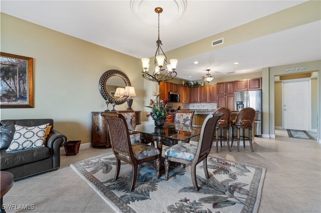 tiled dining area with a chandelier