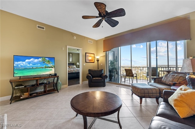 living room with light tile patterned flooring and ceiling fan