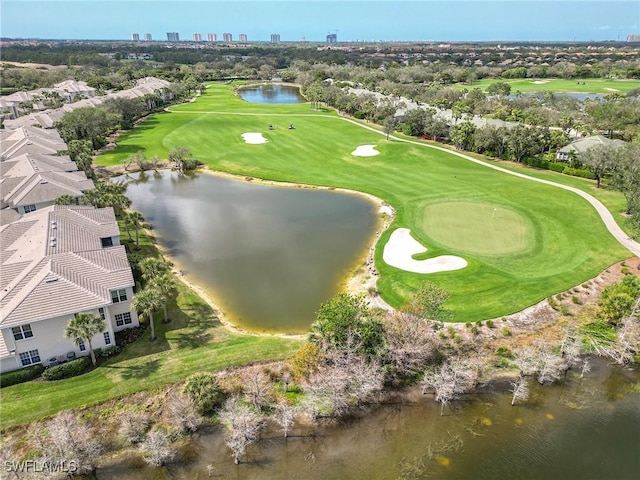 birds eye view of property with a water view and golf course view