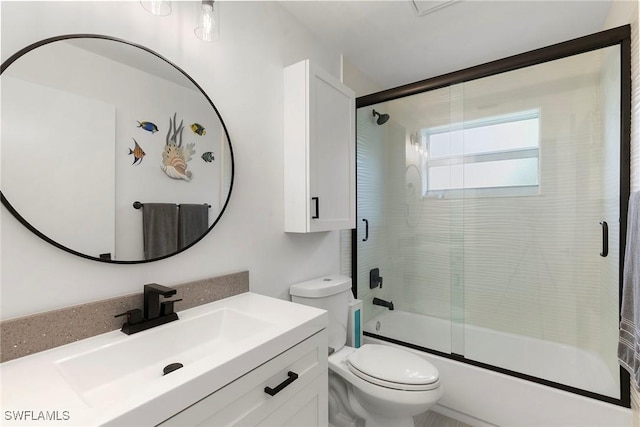 full bath featuring toilet, vanity, and bath / shower combo with glass door