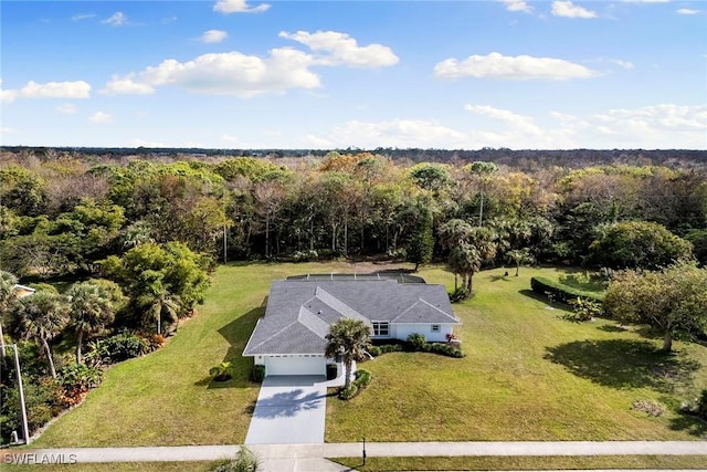 drone / aerial view with a wooded view