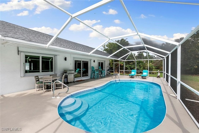 pool featuring a grill, glass enclosure, and a patio