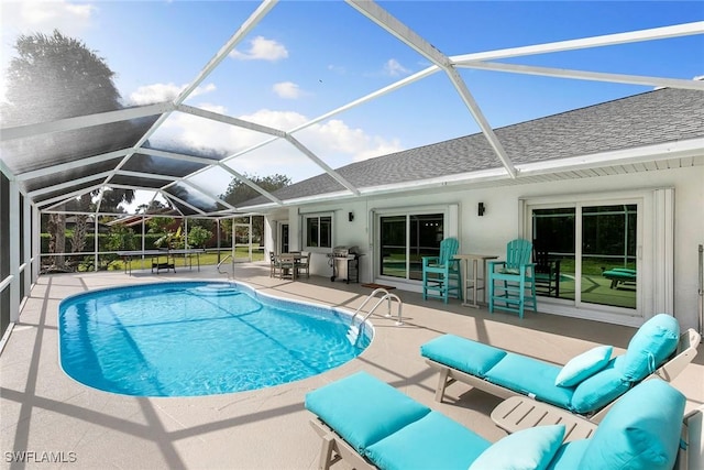 pool with a grill, an outdoor living space, glass enclosure, and a patio