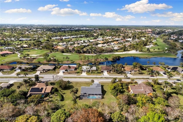 aerial view featuring golf course view, a water view, and a residential view