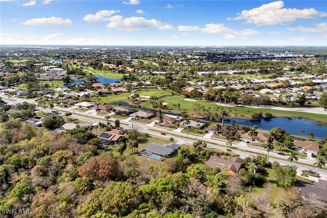 bird's eye view featuring a water view, view of golf course, and a residential view