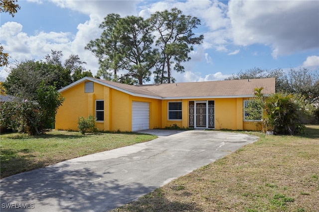 ranch-style house featuring a garage and a front yard