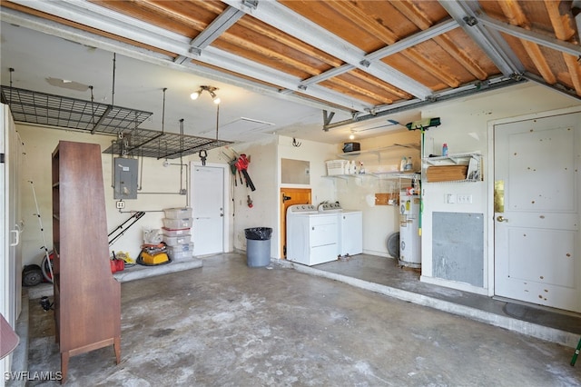 garage featuring washer and clothes dryer, electric panel, and water heater