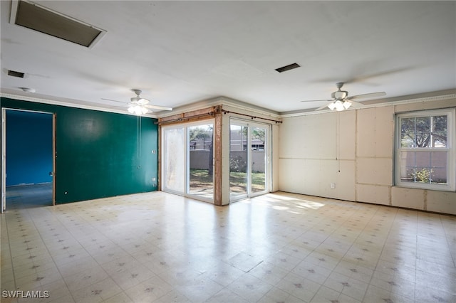 unfurnished room featuring a healthy amount of sunlight and ceiling fan