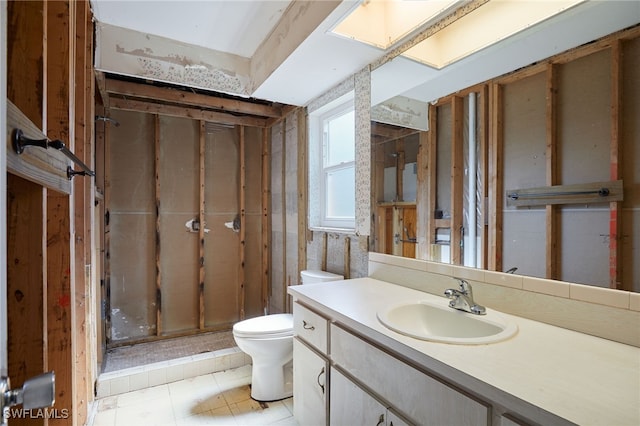 bathroom with vanity, toilet, and tile patterned flooring