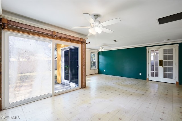 empty room featuring french doors and ceiling fan