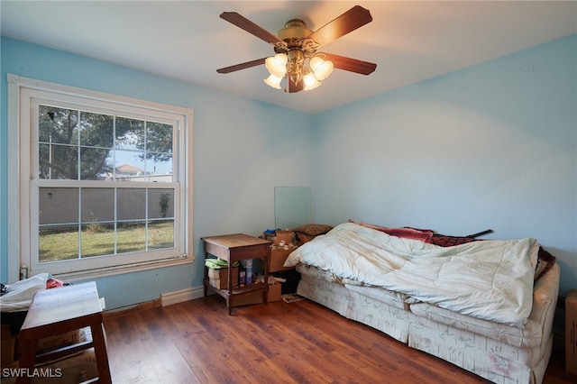 bedroom with ceiling fan and dark hardwood / wood-style flooring