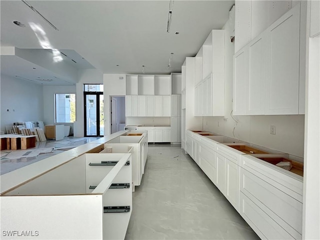 kitchen featuring a kitchen island and white cabinetry