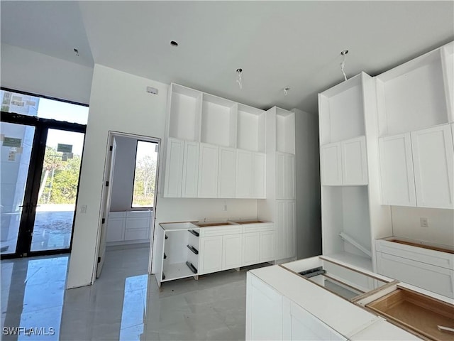 kitchen featuring white cabinetry, french doors, and light tile patterned floors