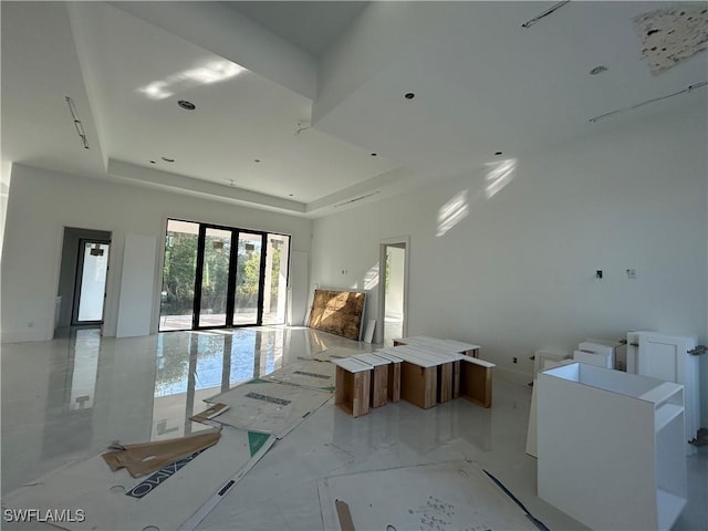 spare room with a raised ceiling and french doors