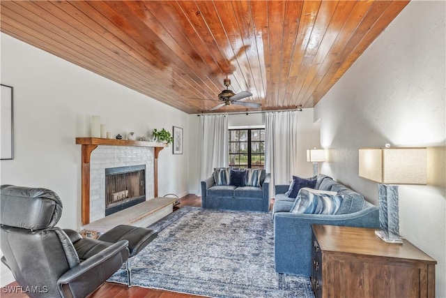 living room with a fireplace, ceiling fan, wooden ceiling, and hardwood / wood-style flooring