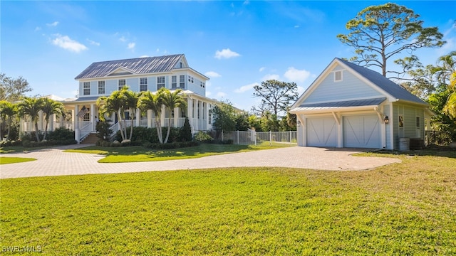 view of front of home with a garage, driveway, fence, a porch, and a front yard