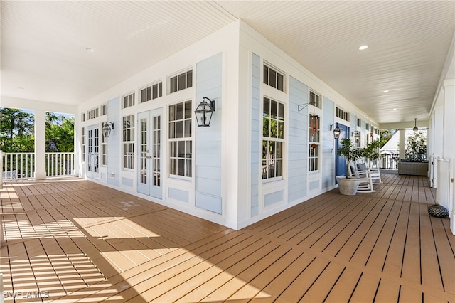 wooden terrace with french doors and a porch