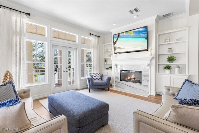 interior space featuring french doors, visible vents, and a fireplace