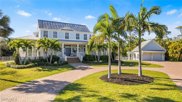 view of front facade featuring decorative driveway, a front yard, covered porch, and a garage