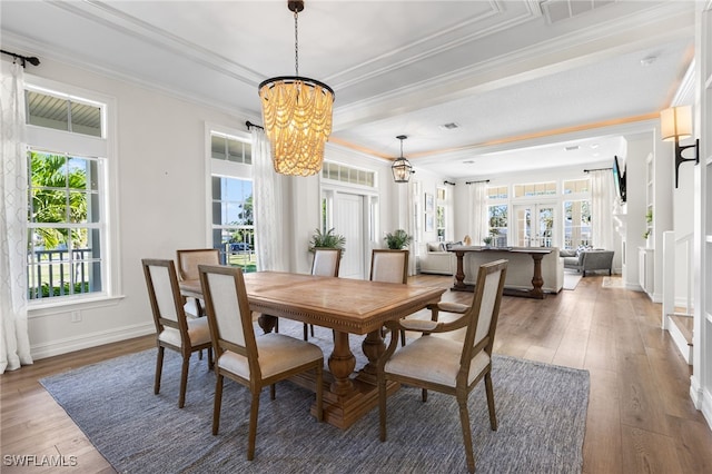 dining room featuring baseboards, ornamental molding, a chandelier, and dark wood-type flooring