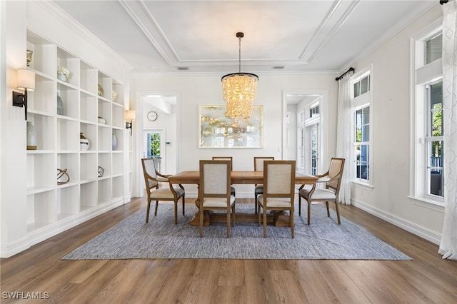 dining space with a chandelier, wood finished floors, and a wealth of natural light