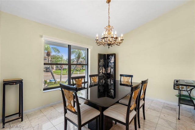 dining space with an inviting chandelier