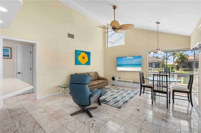 living room with ceiling fan, a healthy amount of sunlight, and high vaulted ceiling