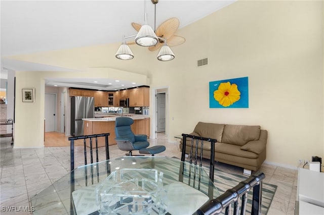 dining area featuring high vaulted ceiling