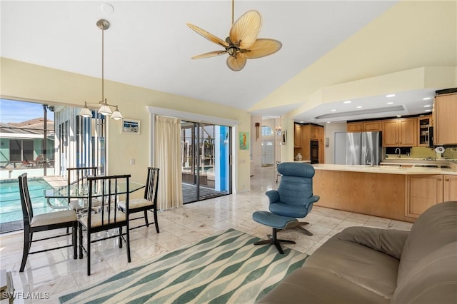 living room with high vaulted ceiling and ceiling fan