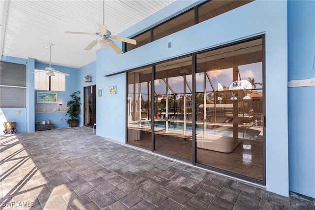 patio terrace at dusk featuring ceiling fan